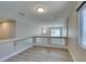 Upstairs hallway with glass railing and hardwood floors leading to other rooms in the home at 10908 Royal Highlands St, Las Vegas, NV 89141