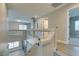 Upstairs hallway with glass railing, hardwood floors, and lots of natural light at 10908 Royal Highlands St, Las Vegas, NV 89141