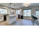 Bright kitchen with large window, white cabinets, stainless steel appliances and countertops at 10908 Royal Highlands St, Las Vegas, NV 89141