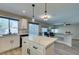 Bright kitchen featuring stainless steel appliances, an island, and views of backyard at 10908 Royal Highlands St, Las Vegas, NV 89141