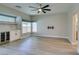 Living room featuring light hardwood floors, a ceiling fan, and a built-in bar with a wine cooler at 10908 Royal Highlands St, Las Vegas, NV 89141