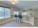 Living room with breakfast bar and view of backyard through large bright windows at 10908 Royal Highlands St, Las Vegas, NV 89141