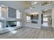 Bright, open-concept living area with stylish fireplace, wood floors, and connecting views to other rooms at 10908 Royal Highlands St, Las Vegas, NV 89141