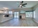 Living room with a ceiling fan, built-in bar, and a view of the pool at 10908 Royal Highlands St, Las Vegas, NV 89141
