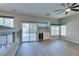 Living room with a ceiling fan, built-in bar, and sliding doors leading to the pool at 10908 Royal Highlands St, Las Vegas, NV 89141
