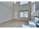 Bright, open living room with a fireplace, large windows, and stylish wood-look flooring at 10908 Royal Highlands St, Las Vegas, NV 89141