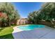 Private backyard pool offers a serene escape amidst mature landscaping at 10908 Royal Highlands St, Las Vegas, NV 89141