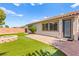 Charming backyard featuring a brick laid patio, small yard and fire pit at 11764 Golden Moments Ave, Las Vegas, NV 89138