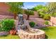 Idyllic backyard showcasing the decorative waterfall feature and lush landscaping at 11764 Golden Moments Ave, Las Vegas, NV 89138