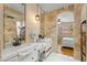 Stunning bathroom featuring a double sink vanity, stone countertops, tiled walls, and modern fixtures at 11764 Golden Moments Ave, Las Vegas, NV 89138