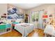 Well-lit bedroom with charming décor, large window, and ample space for relaxation at 11764 Golden Moments Ave, Las Vegas, NV 89138