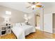 Comfortable bedroom featuring hardwood floors, ceiling fan, and ensuite bathroom with a tiled shower at 11764 Golden Moments Ave, Las Vegas, NV 89138
