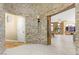 Elegant foyer featuring a stone accent wall, tile flooring, and open access to the living room at 11764 Golden Moments Ave, Las Vegas, NV 89138