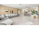 Inviting living room with tile floors, a large sectional sofa and a kitchen island at 11764 Golden Moments Ave, Las Vegas, NV 89138
