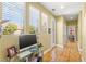 Bright home office area with hardwood floors, large window, and glass top desk at 11764 Golden Moments Ave, Las Vegas, NV 89138