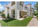 Spacious backyard featuring a covered patio, artificial turf and manicured landscaping at 11775 Woodbrook Ct, Las Vegas, NV 89141