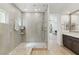 Bright bathroom featuring a glass shower with hexagon tile floor and double sink vanity at 11775 Woodbrook Ct, Las Vegas, NV 89141
