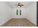 Bright bedroom with wood flooring and arched windows offering ample natural light at 11775 Woodbrook Ct, Las Vegas, NV 89141