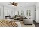 Bedroom with neutral decor, shuttered windows, and comfortable seating area at 11775 Woodbrook Ct, Las Vegas, NV 89141