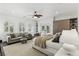 Cozy bedroom showcasing shuttered windows, a ceiling fan, and a seating area at 11775 Woodbrook Ct, Las Vegas, NV 89141