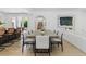 Bright dining room featuring a large table, stylish chairs, and an open view to the living area and staircase at 11775 Woodbrook Ct, Las Vegas, NV 89141