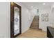 Elegant entryway with decorative glass door, staircase, and hardwood flooring at 11775 Woodbrook Ct, Las Vegas, NV 89141