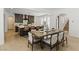 Modern open concept kitchen with a large island, stainless steel appliances, and dark wood cabinets at 11775 Woodbrook Ct, Las Vegas, NV 89141