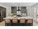 Spacious kitchen featuring a large center island, white countertops, and dark wood cabinetry and finishes at 11775 Woodbrook Ct, Las Vegas, NV 89141