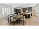 Open-concept kitchen and dining area with dark cabinets, large island, and contemporary design at 11775 Woodbrook Ct, Las Vegas, NV 89141