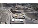 Aerial view of a new community under construction in a hilly area, showing multiple homes being built with city views at 1204 Powerwall Pl, Henderson, NV 89012