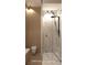 Bright bathroom featuring sleek black fixtures, modern vessel sink, frameless glass shower, and neutral wood-look walls at 1204 Powerwall Pl, Henderson, NV 89012