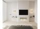 Bright bedroom with a fireplace, a TV, and unique sconces for a cozy and stylish space at 1204 Powerwall Pl, Henderson, NV 89012