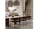 Modern dining room with designer lighting, seating for eight, and adjacent to a chef's kitchen at 1204 Powerwall Pl, Henderson, NV 89012