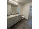 Bathroom featuring gray cabinets, granite countertops, and a shower/tub combo at 12170 Midnight Pine Rd # 3, Las Vegas, NV 89183