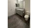 Bathroom features wood-look flooring, granite vanity and a modern toilet at 12170 Midnight Pine Rd # 3, Las Vegas, NV 89183