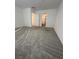 Spacious bedroom with gray carpeting and doorways to a bathroom and closet at 12170 Midnight Pine Rd # 3, Las Vegas, NV 89183