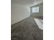 Spacious bedroom with gray carpeting and a window allowing natural light at 12170 Midnight Pine Rd # 3, Las Vegas, NV 89183