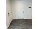 Hallway with a coat rack and gray vinyl flooring near a front door at 12170 Midnight Pine Rd # 3, Las Vegas, NV 89183