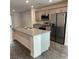 Modern kitchen with stainless steel appliances, gray cabinetry, and a large island at 12170 Midnight Pine Rd # 3, Las Vegas, NV 89183