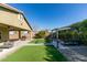 Attractive backyard with artificial turf, outdoor seating, grill and pergola at 124 Strone St, Henderson, NV 89012