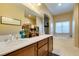 Bathroom featuring dual sinks, a soaking tub, and bright natural light at 124 Strone St, Henderson, NV 89012