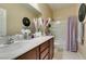 Bathroom featuring single sink vanity with drawers and cabinets, a shower-tub combo, and modern fixtures at 124 Strone St, Henderson, NV 89012
