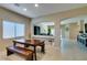 Bright dining area with a wooden table and bench seating, perfect for Gathering meals at 124 Strone St, Henderson, NV 89012