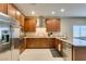 Kitchen with stainless appliances, granite counters, and plenty of storage in wood cabinetry at 124 Strone St, Henderson, NV 89012