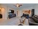 Comfortable living room with a TV, media console, and an open view into the well-equipped kitchen at 124 Strone St, Henderson, NV 89012