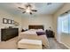 Serene main bedroom featuring neutral walls, ceiling fan, and lots of natural light at 124 Strone St, Henderson, NV 89012