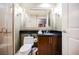 Modern bathroom features a walk-in shower, toilet, and vanity with a black countertop and dark wood cabinetry at 135 E Harmon Ave # 2420, Las Vegas, NV 89109