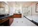 Spacious bathroom features dual vanities, a walk-in shower, and a soaking tub, perfect for a relaxing at-home spa day at 135 E Harmon Ave # 2420, Las Vegas, NV 89109