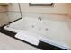 This bathroom has a luxurious soaking tub with jets and a black countertop for an elegant bathing experience at 135 E Harmon Ave # 2420, Las Vegas, NV 89109