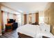 Comfortable bedroom with a king-size bed, large windows with privacy curtains, and a work desk area at 135 E Harmon Ave # 2420, Las Vegas, NV 89109